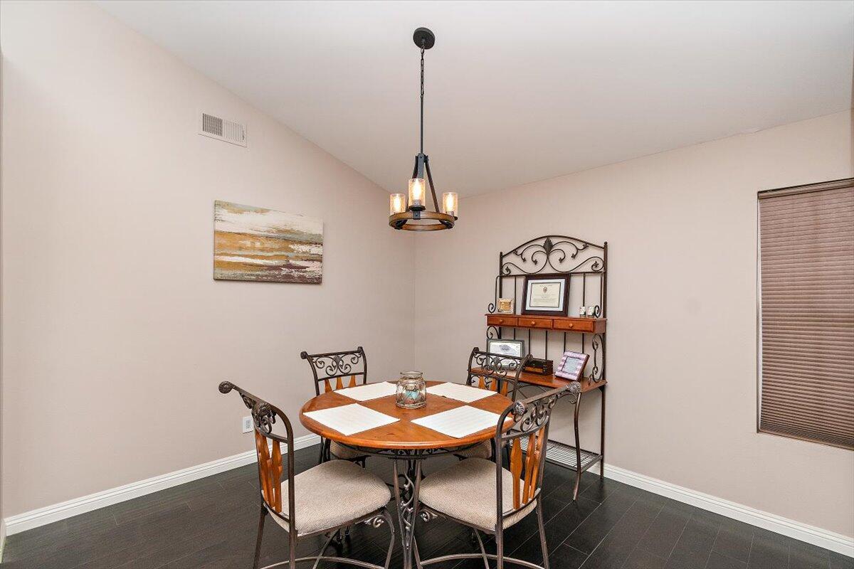 45510 Desert Fox Drive La Quinta, CA 92253 - Photo 26 of 49 a view of a dining room with furniture wooden floor and a chandelier