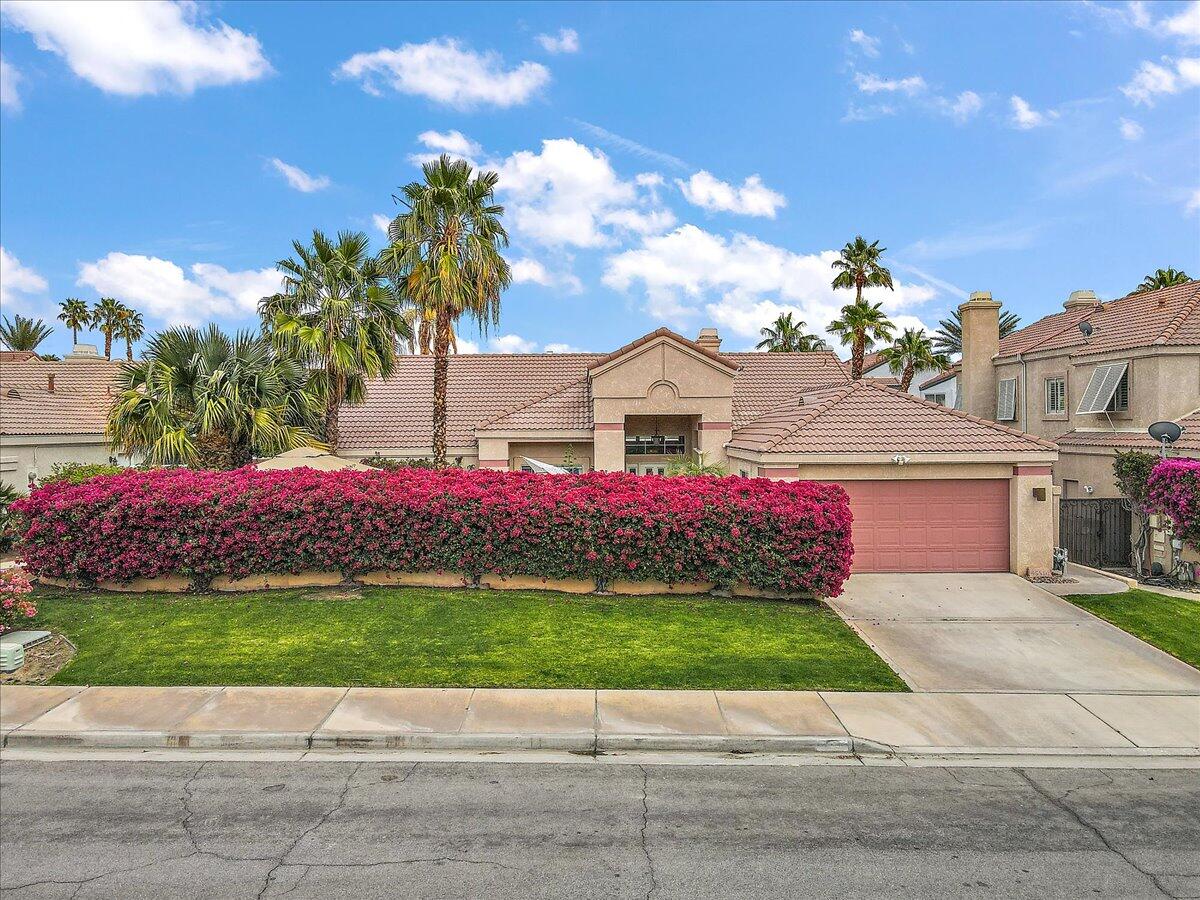 45510 Desert Fox Drive La Quinta, CA 92253 - Photo 3 of 49 a view of a white house with a yard and potted plants