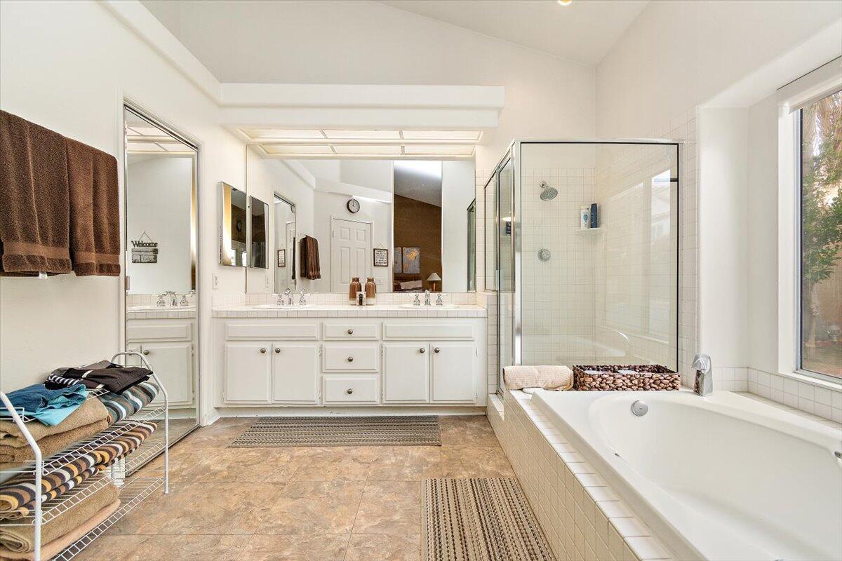 45510 Desert Fox Drive La Quinta, CA 92253 - Photo 39 of 49 a spacious bathroom with a tub sink and mirror