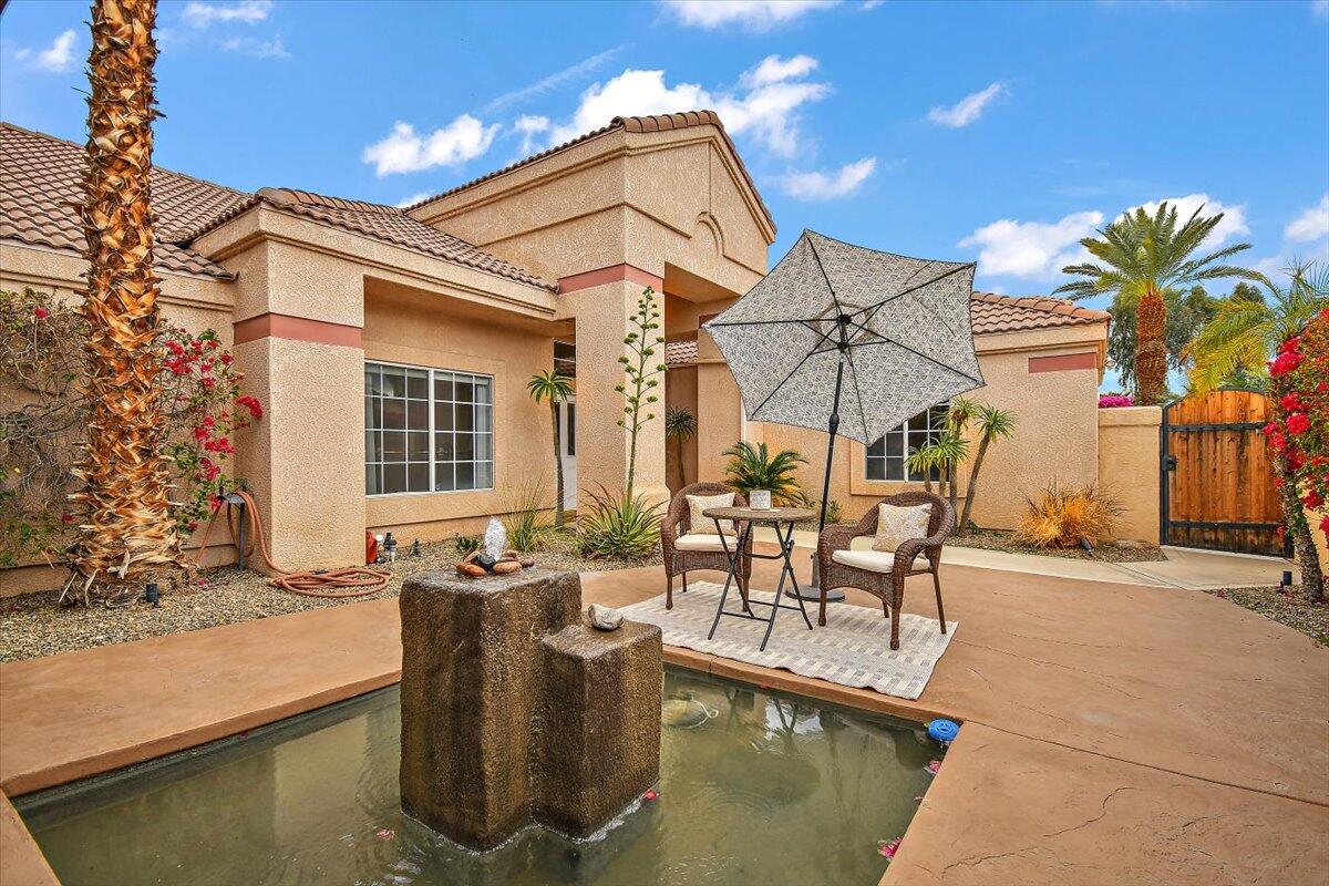 45510 Desert Fox Drive La Quinta, CA 92253 - Photo 8 of 49 a view of a patio with table and chairs and potted plants