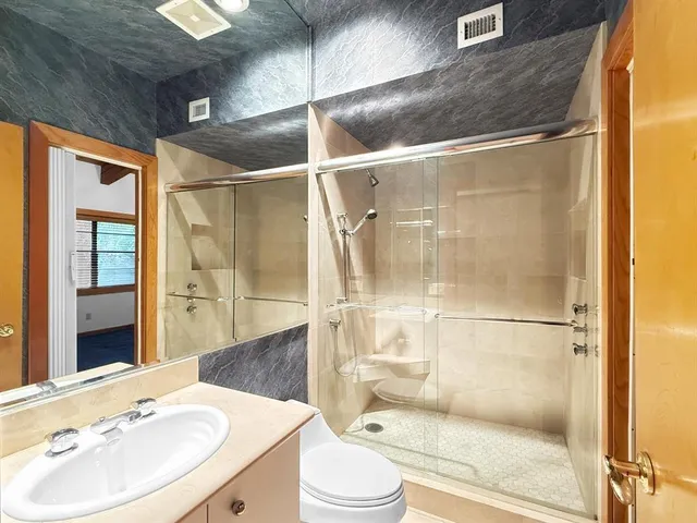 a bathroom with a sink toilet and shower