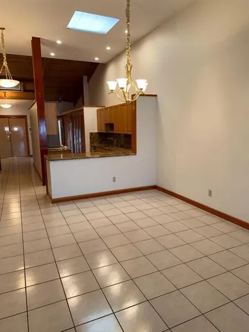 a view of a kitchen with a sink and a refrigerator