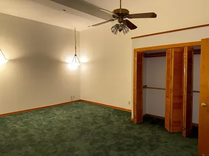 a view of empty room with ceiling fan