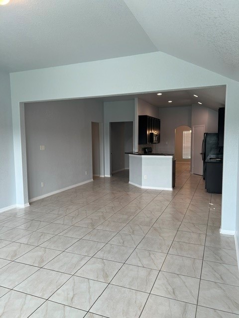 18303 Ranch View Trail Houston, TX 77073 - Photo 19 of 19 Spacious open floor plan with elegant tile flooring, modern kitchen featuring sleek appliances, and abundant natural light.