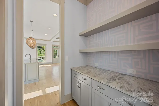 a kitchen with a sink a counter space appliances and cabinets