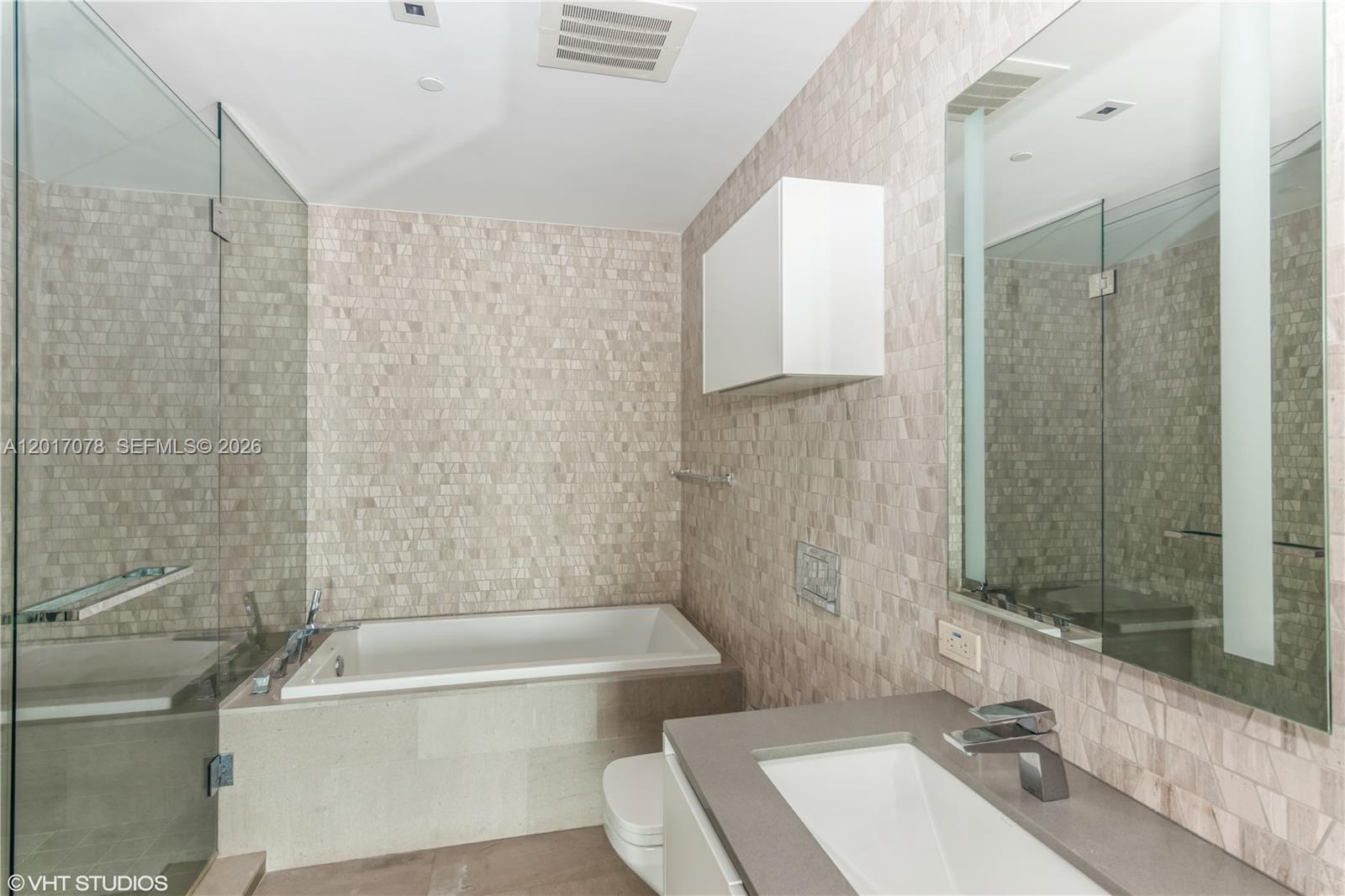 88 Southwest 7th Street, Unit 2508 Miami, FL 33130 - Photo 11 of 18 a bathroom with a sink a toilet and shower