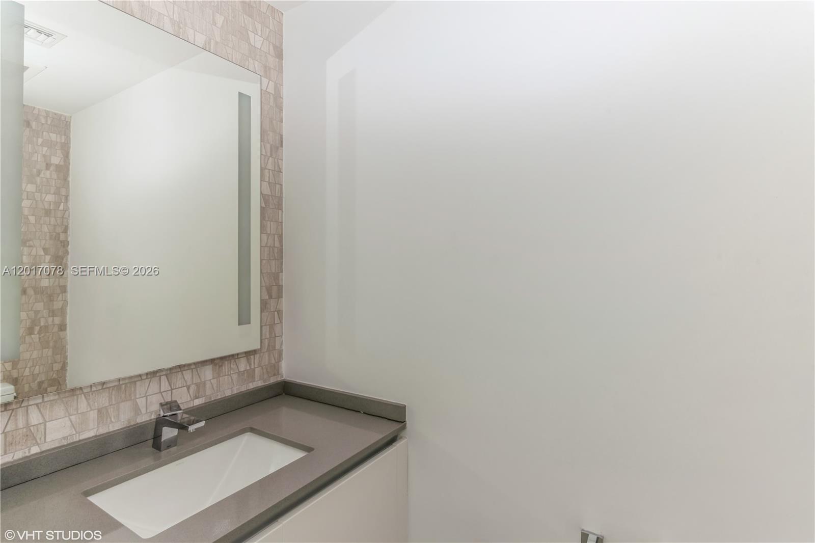 88 Southwest 7th Street, Unit 2508 Miami, FL 33130 - Photo 14 of 18 a bathroom with a sink and a mirror