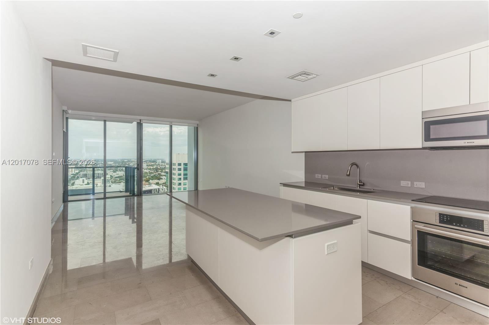 88 Southwest 7th Street, Unit 2508 Miami, FL 33130 - Photo 3 of 18 a kitchen with a sink and large window