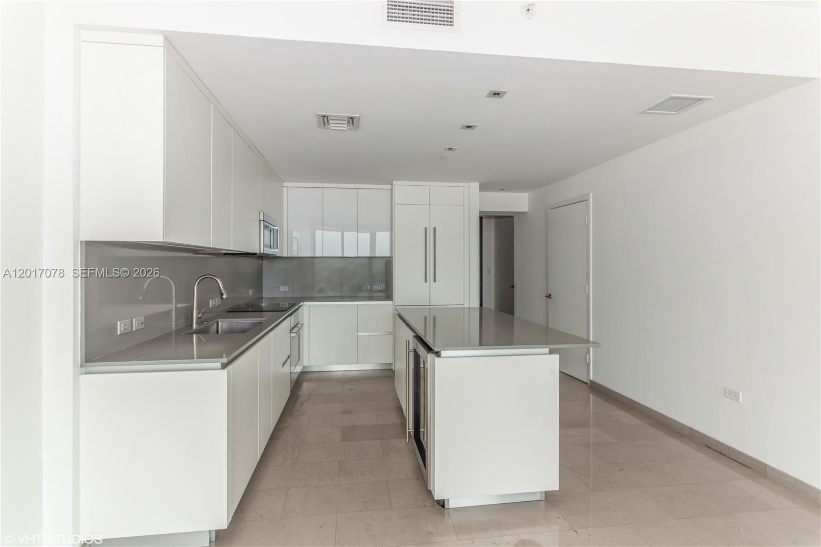 88 Southwest 7th Street, Unit 2508 Miami, FL 33130 - Photo 6 of 18 a kitchen with a sink a stove and refrigerator