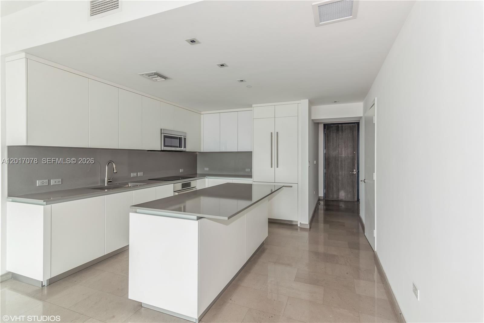 88 Southwest 7th Street, Unit 2508 Miami, FL 33130 - Photo 7 of 18 a kitchen with stainless steel appliances granite countertop a sink and a refrigerator