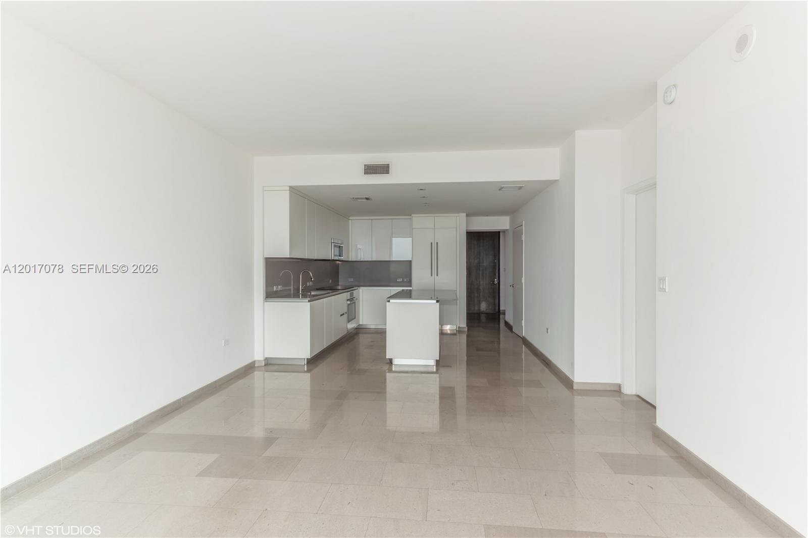 88 Southwest 7th Street, Unit 2508 Miami, FL 33130 - Photo 8 of 18 a view of a kitchen and an empty room