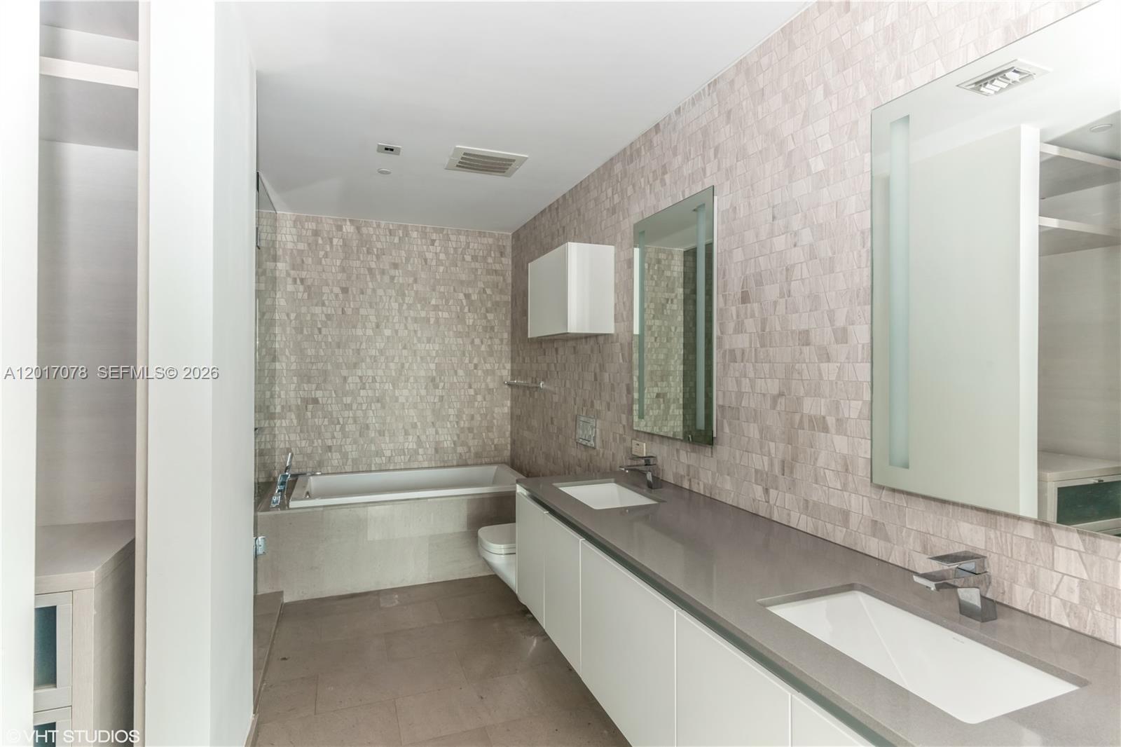 88 Southwest 7th Street, Unit 2508 Miami, FL 33130 - Photo 10 of 18 a bathroom with a tub sink and mirror