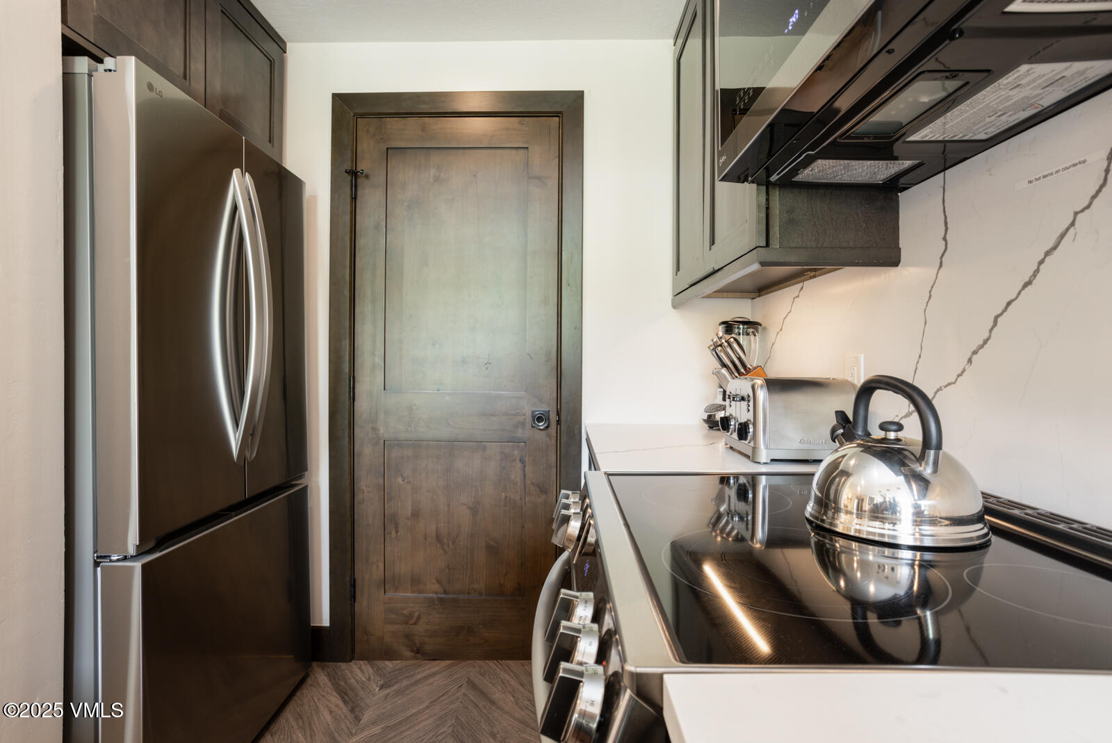 120 Offerson Road, Unit 3430 Beaver Creek, CO 81620 - Photo 11 of 36 a kitchen with a sink and refrigerator