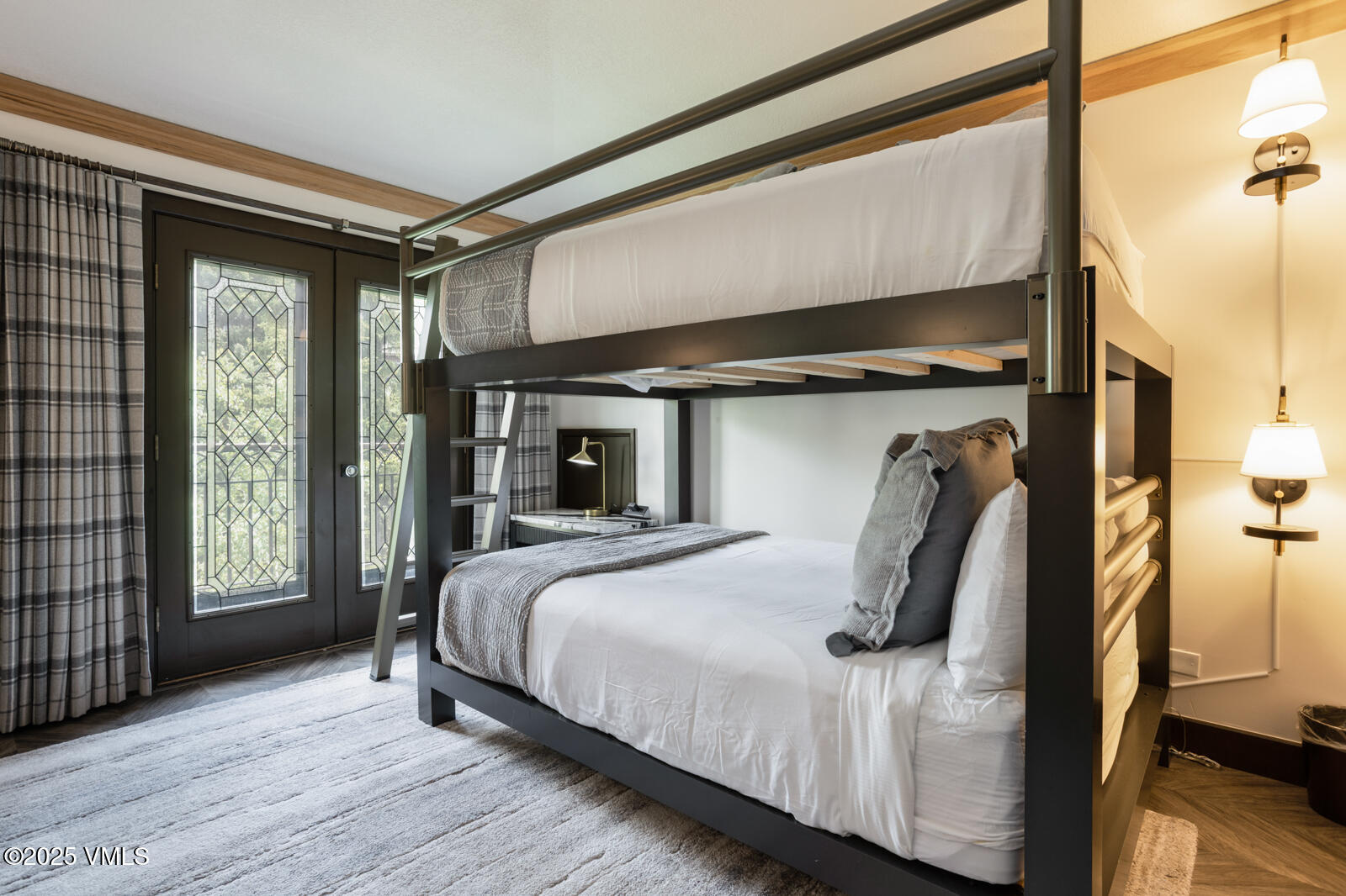 120 Offerson Road, Unit 3430 Beaver Creek, CO 81620 - Photo 23 of 36 a bedroom with a bed and wooden floor