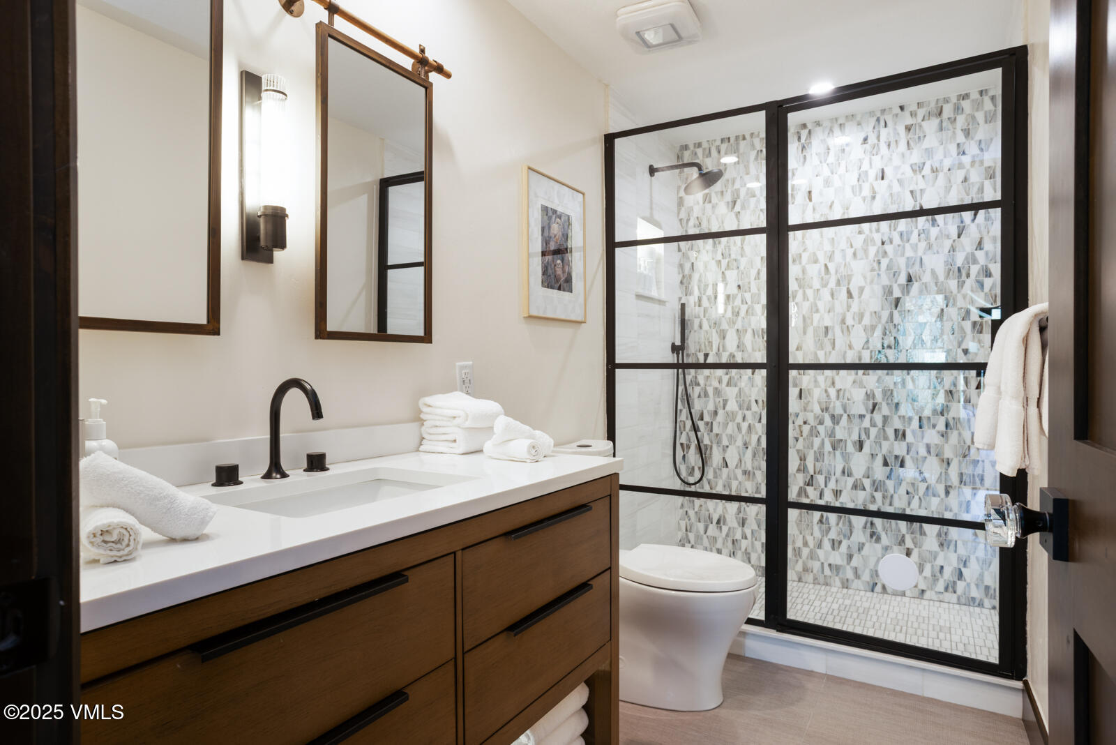 120 Offerson Road, Unit 3430 Beaver Creek, CO 81620 - Photo 26 of 36 a bathroom with a granite countertop sink toilet a mirror and shower