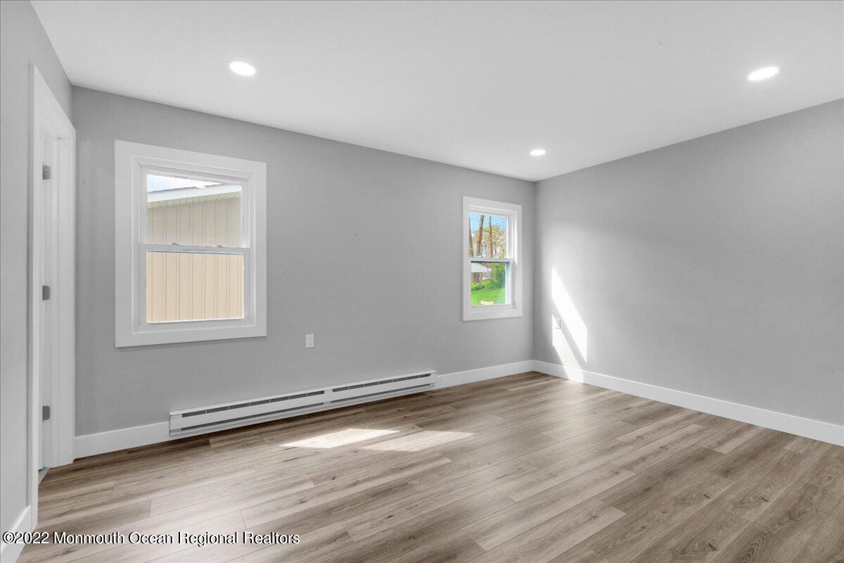 2 Bryant Road Brick, NJ 08724 - Photo 15 of 28 an empty room with wooden floor and windows