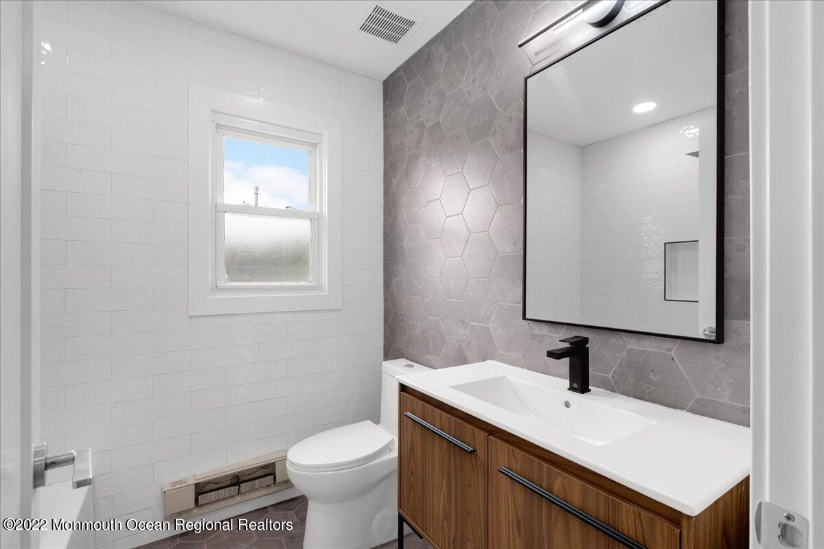 2 Bryant Road Brick, NJ 08724 - Photo 19 of 28 a bathroom with a toilet sink vanity and mirror