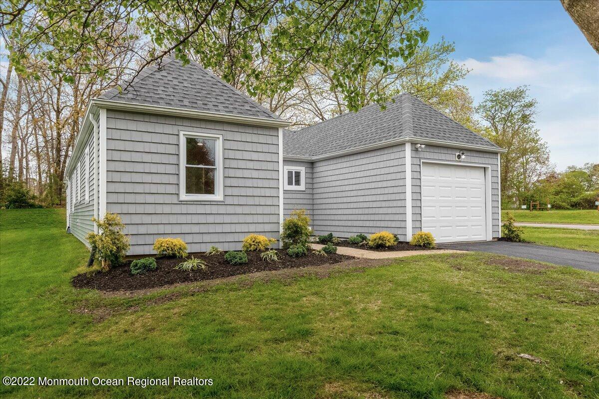2 Bryant Road Brick, NJ 08724 - Photo 2 of 28 a front view of a house with a garden and yard
