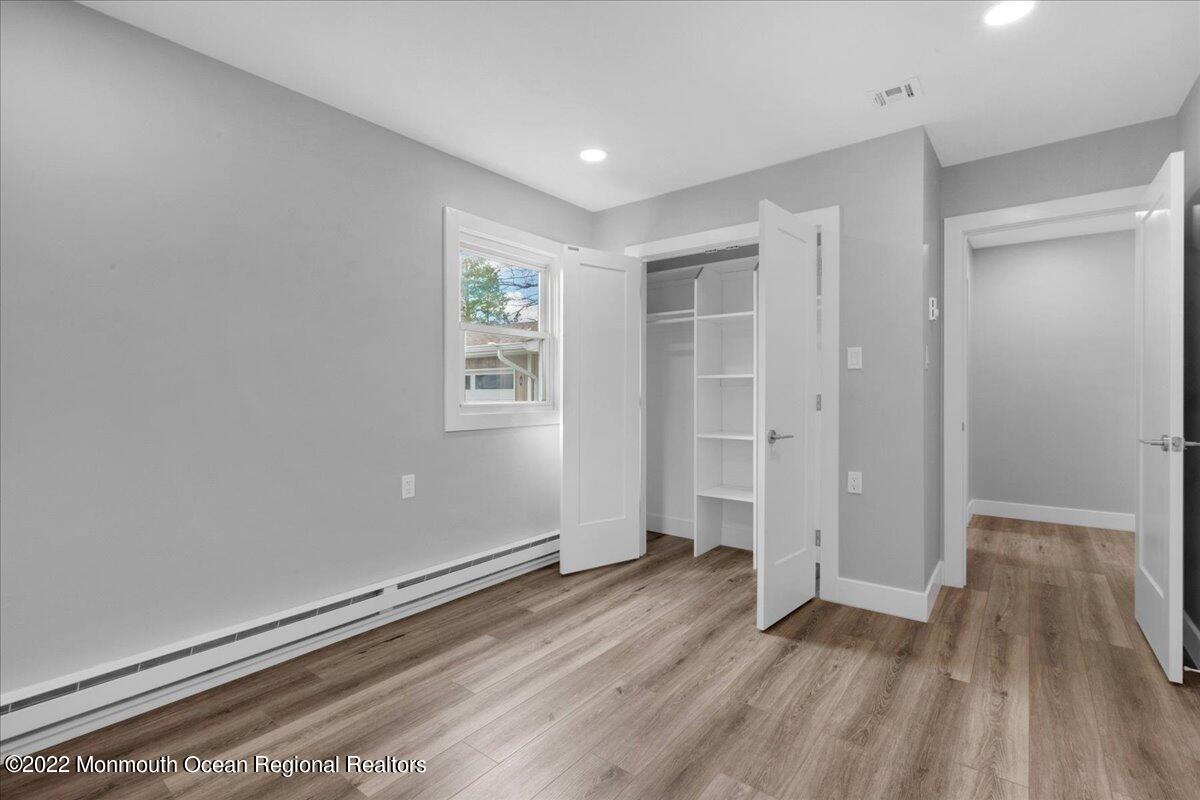 2 Bryant Road Brick, NJ 08724 - Photo 8 of 28 an empty room with wooden floor and windows