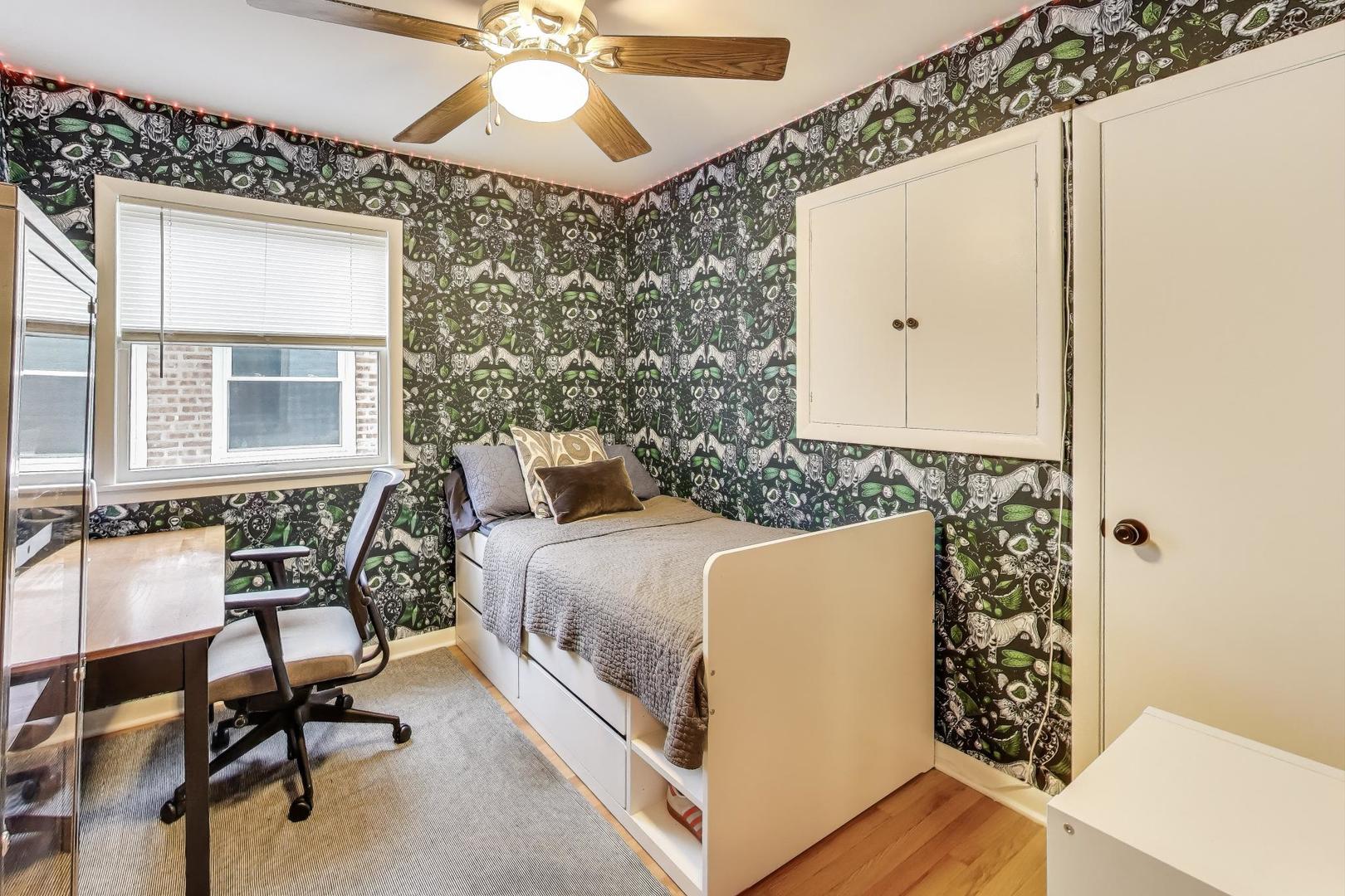 235 Richmond Street Evanston, IL 60202 - Photo 17 of 38 a bedroom with a bed a chair and a potted plant