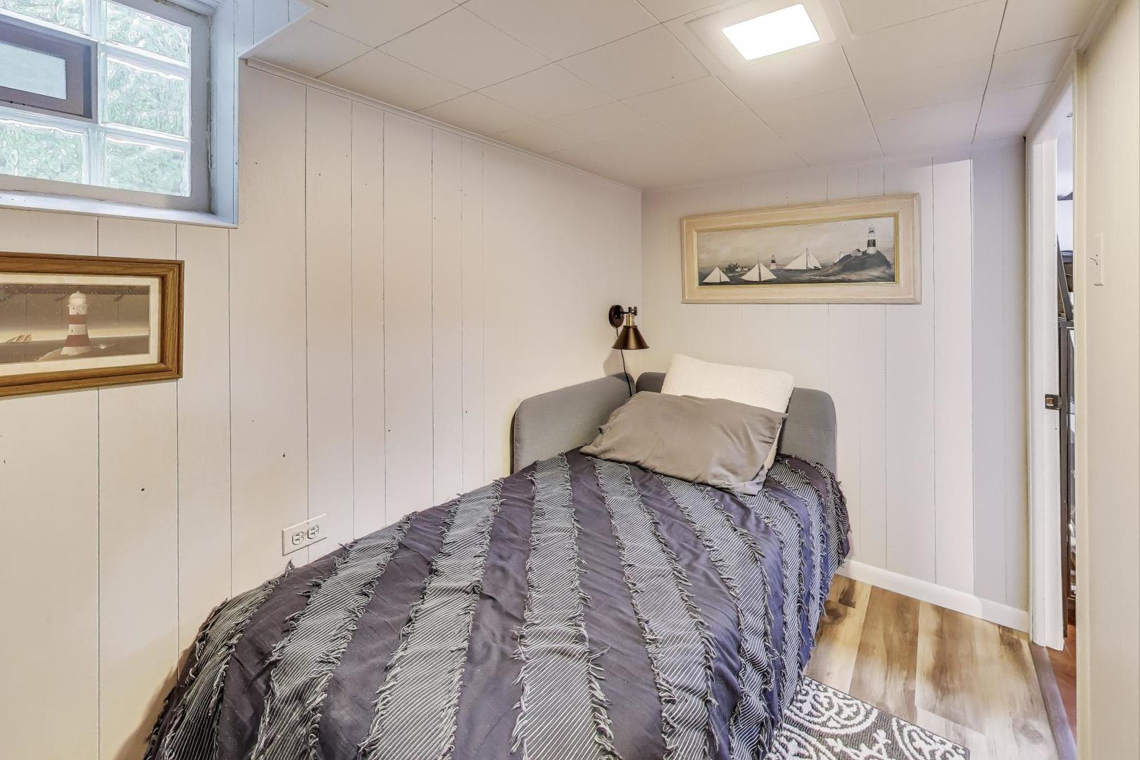 235 Richmond Street Evanston, IL 60202 - Photo 28 of 38 a bed sitting in a bedroom next to a bathroom