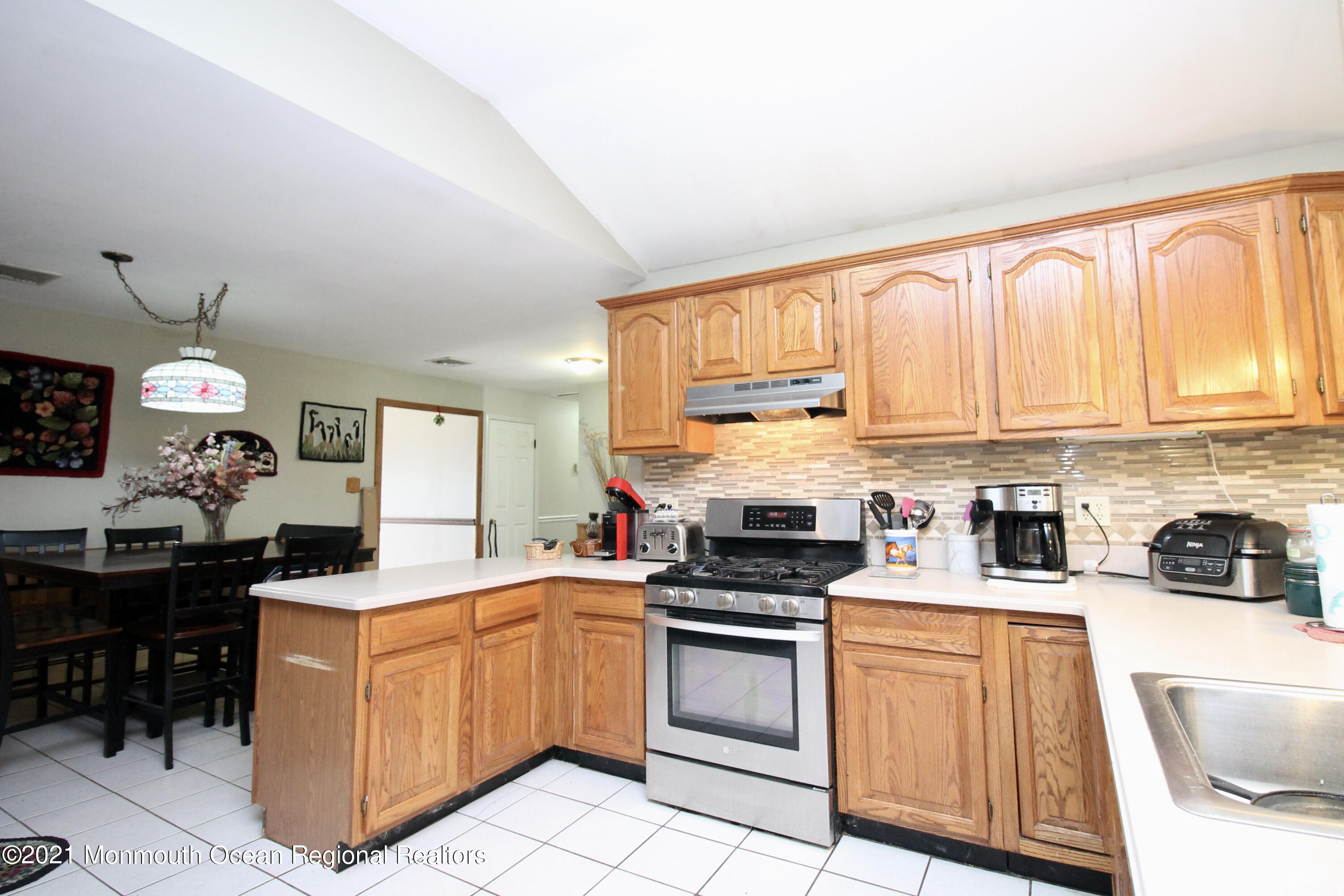866 Monmouth Road Cream Ridge, NJ 08514 - Photo 15 of 39 a kitchen with a sink stove top oven and cabinets
