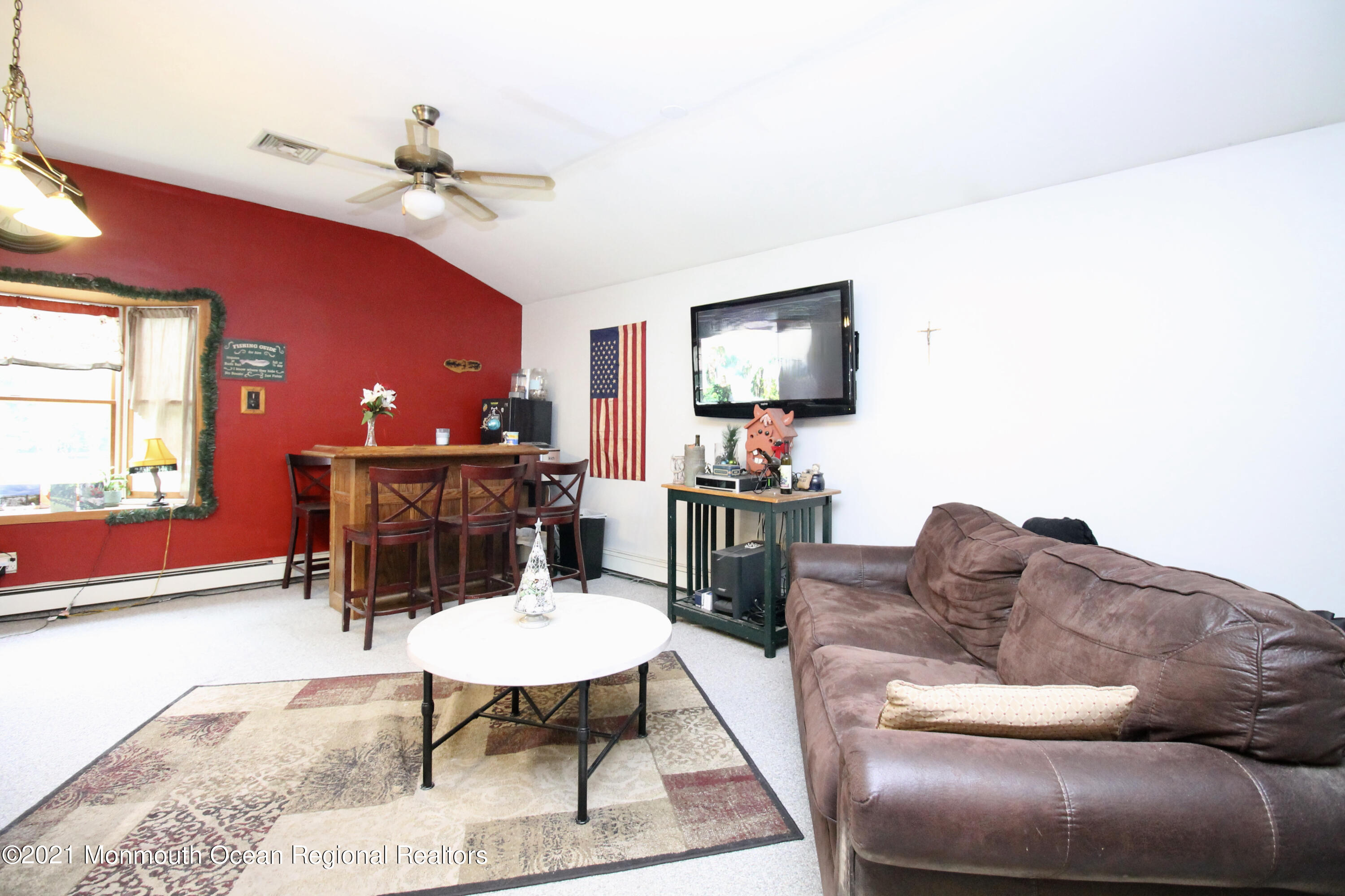 866 Monmouth Road Cream Ridge, NJ 08514 - Photo 20 of 39 a living room with furniture and a flat screen tv