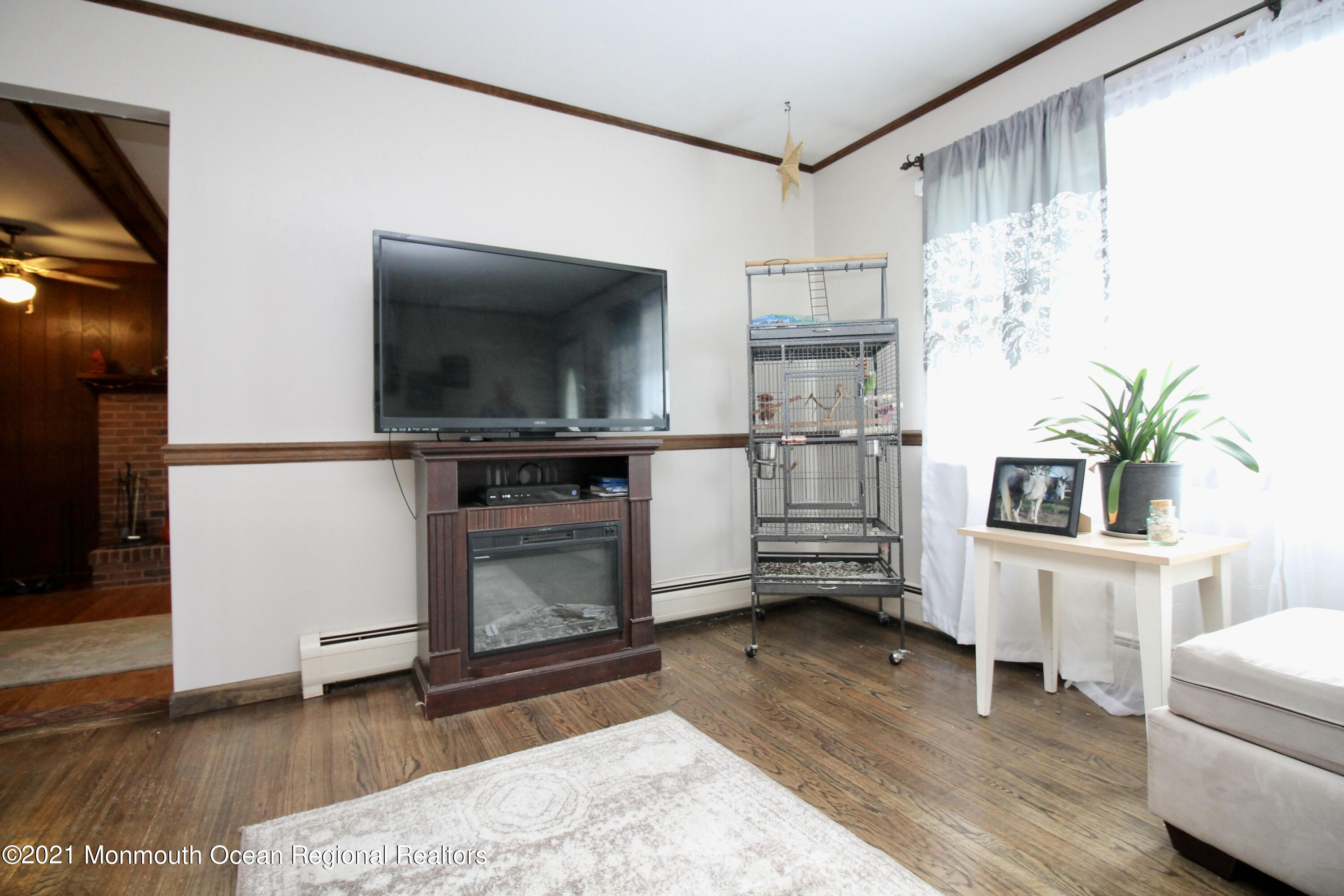 866 Monmouth Road Cream Ridge, NJ 08514 - Photo 4 of 39 a living room with furniture a flat screen tv and a fireplace