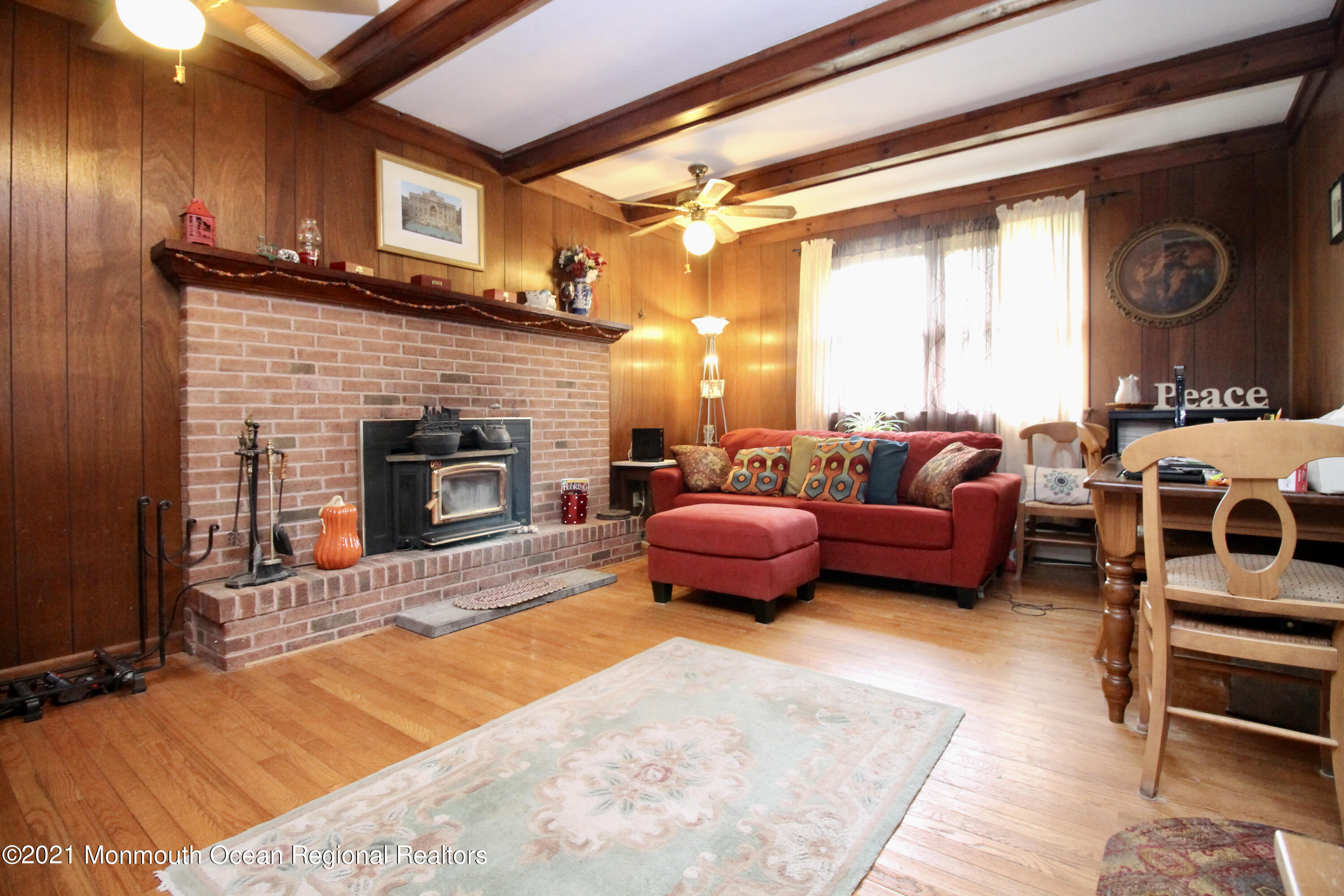 866 Monmouth Road Cream Ridge, NJ 08514 - Photo 6 of 39 a living room with furniture a fireplace and a flat screen tv