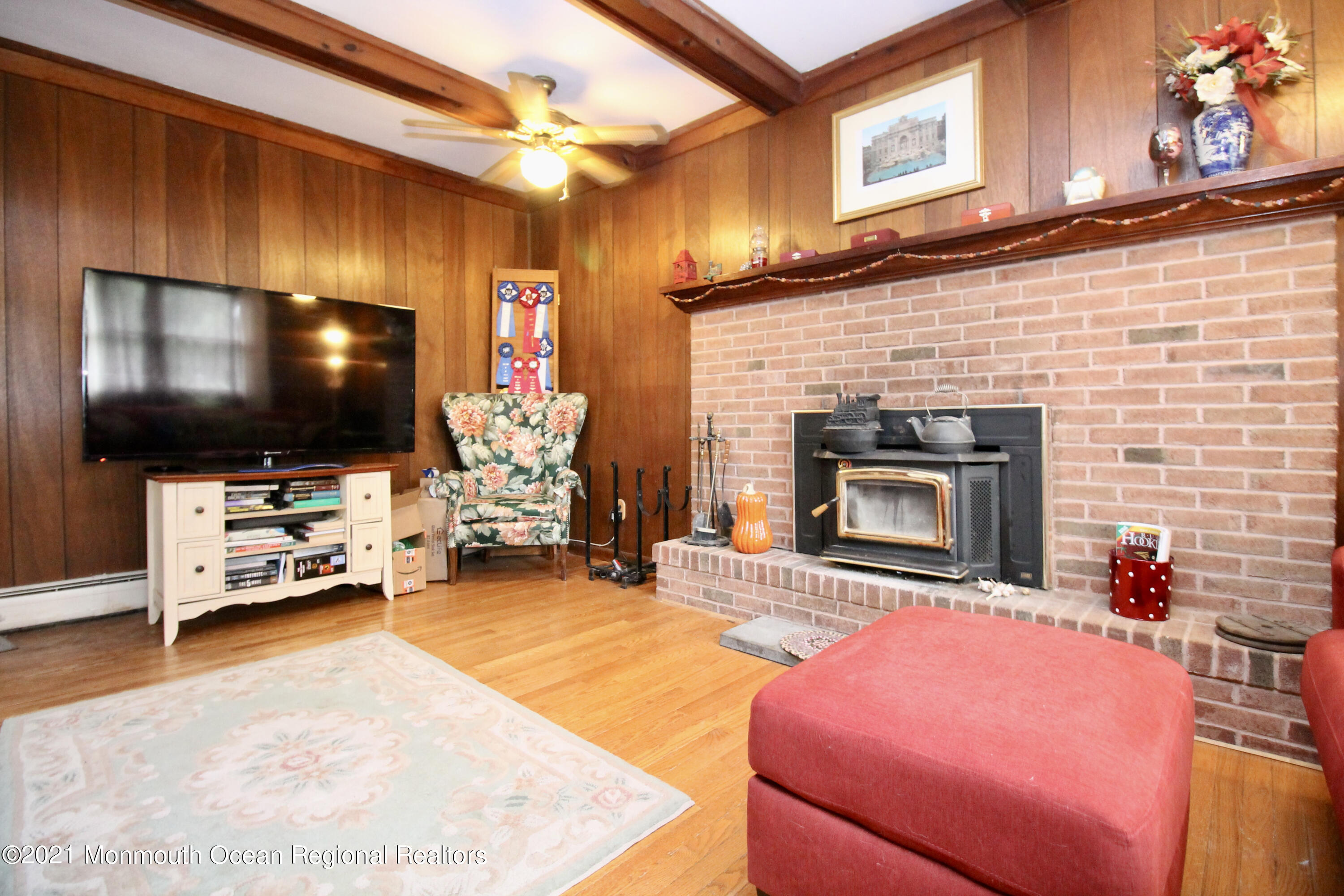 866 Monmouth Road Cream Ridge, NJ 08514 - Photo 7 of 39 a living room with fireplace furniture and a flat screen tv