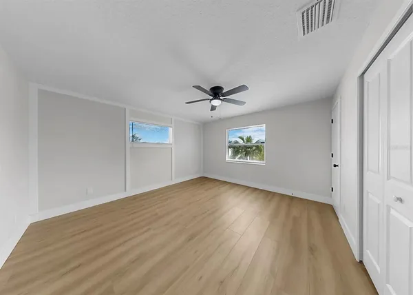 a bedroom with a large bed and a couch