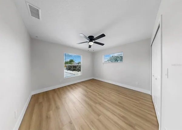 a bedroom with a large bed and a chandelier