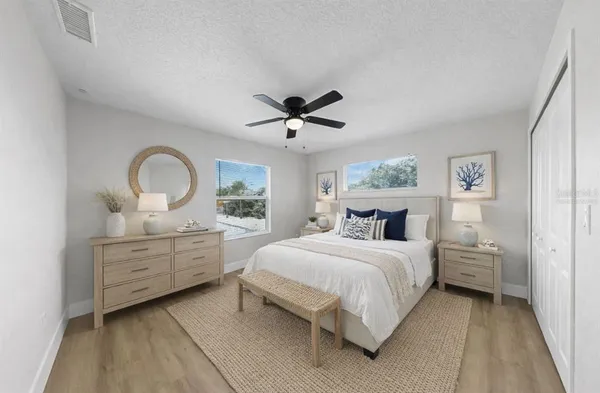 a spacious bathroom with 2 sink mirror and shower