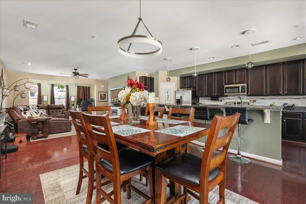 a group of people sitting in a kitchen