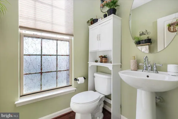 a bathroom with a sink toilet and mirror