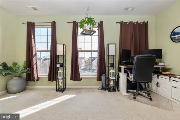 a view of workspace with furniture and a window