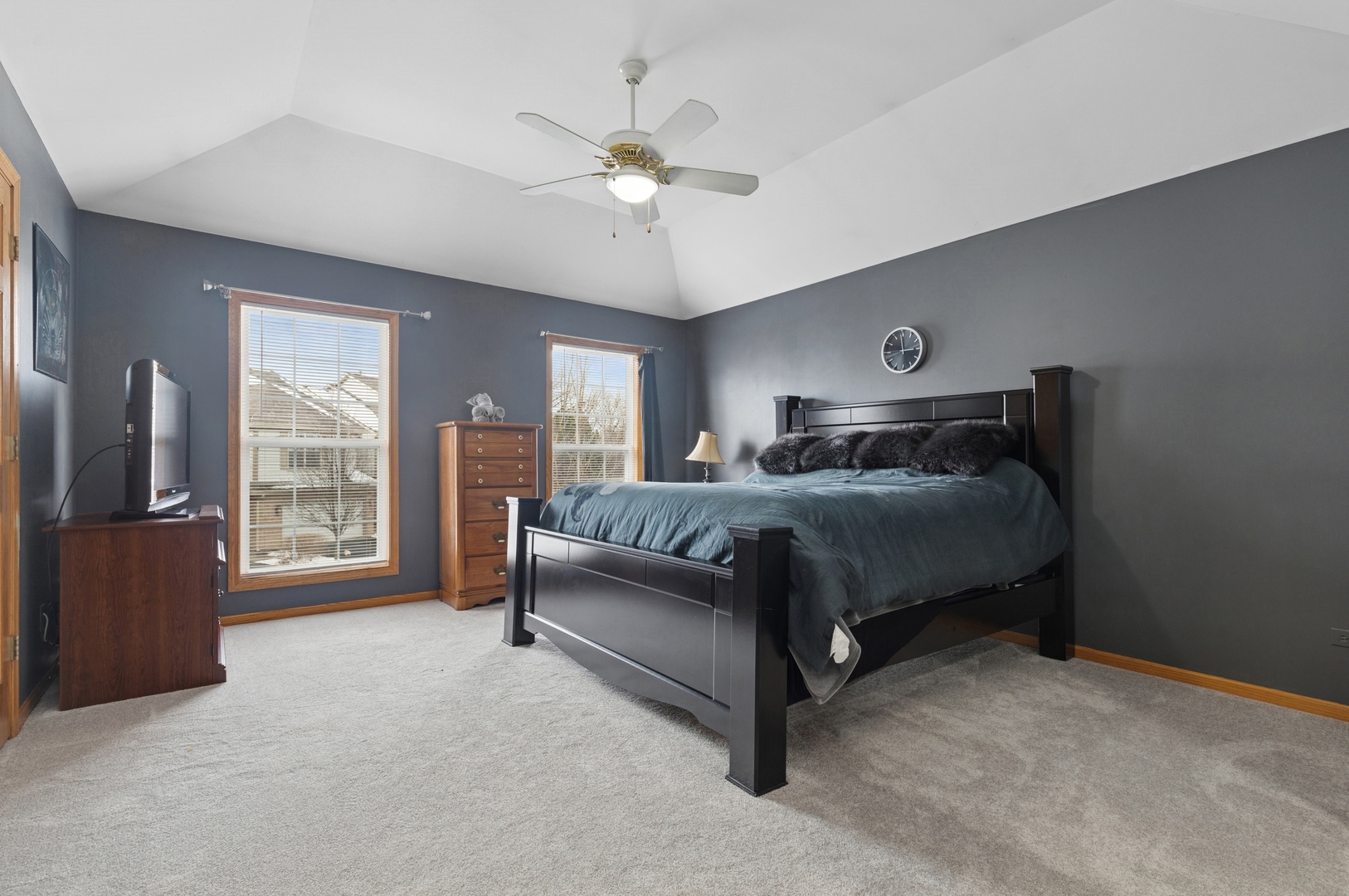 2014 Ivy Ridge Drive Hoffman Estates, IL 60192 - Photo 12 of 14 a bedroom with a bed and a chandelier