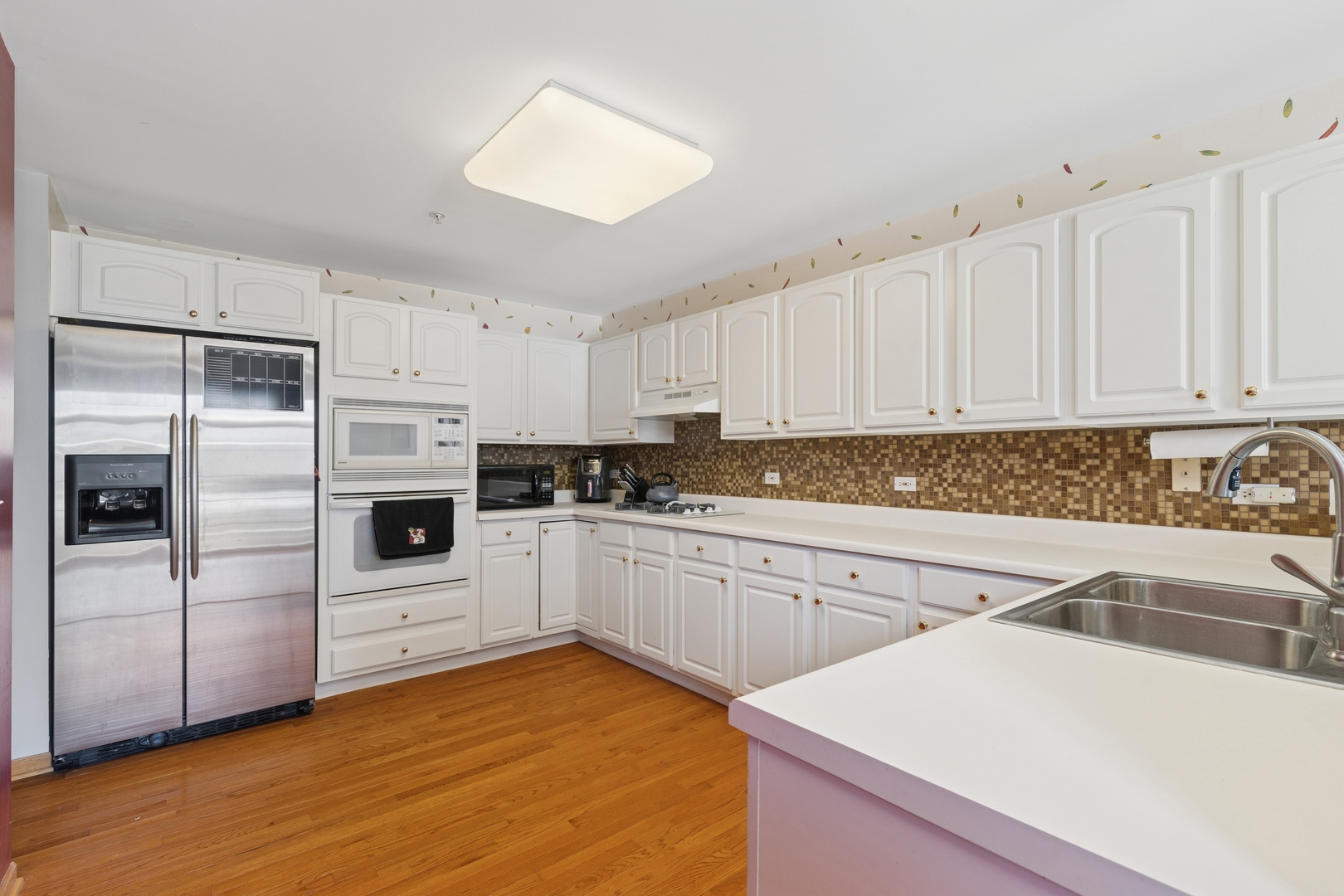 2014 Ivy Ridge Drive Hoffman Estates, IL 60192 - Photo 8 of 14 a kitchen with a sink a refrigerator and white cabinets