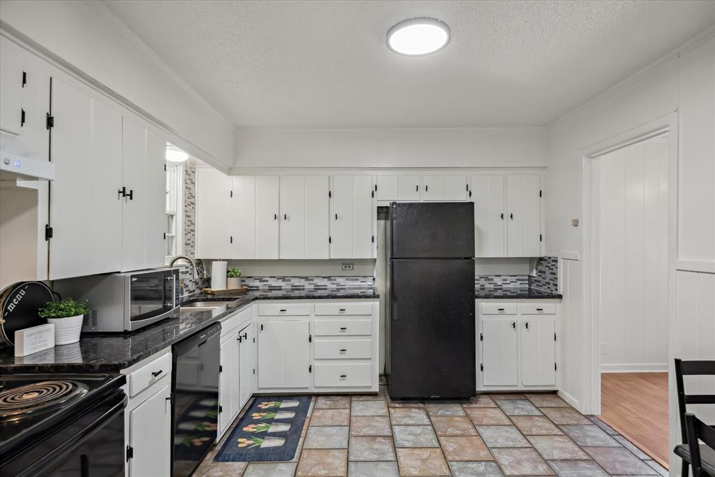 1460 Forrest Drive Canton, TX 75103 - Photo 11 of 36 a kitchen with a refrigerator stove and cabinets
