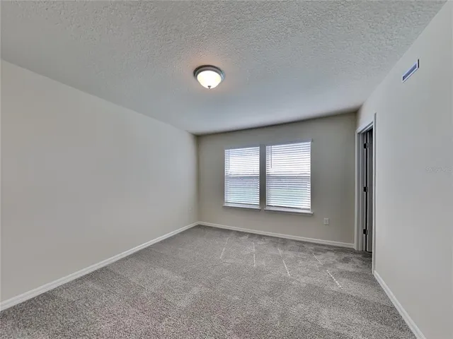 an empty room with a empty space and windows