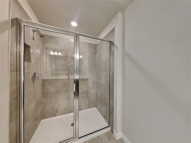 a bathroom with a glass shower door