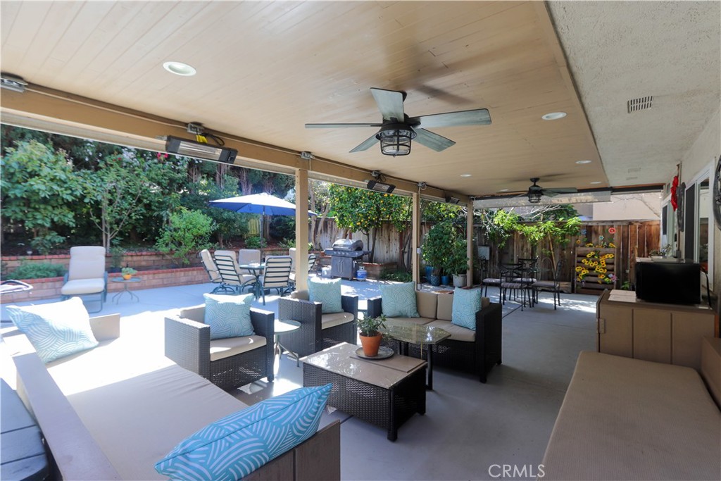 a living room with patio furniture and a large window
