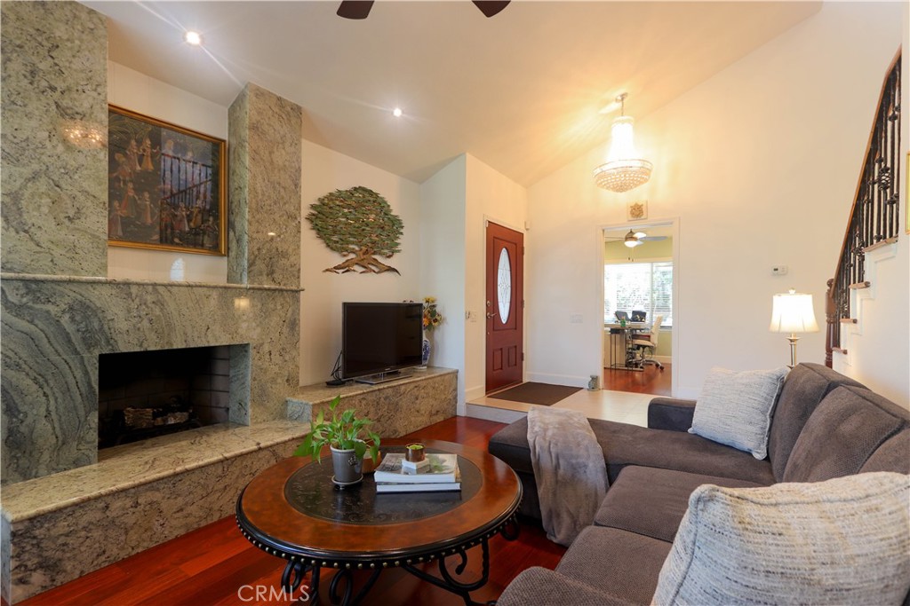 8 Sandpiper Irvine, CA 92604 - Photo 12 of 45 a living room with furniture a fireplace and a flat screen tv