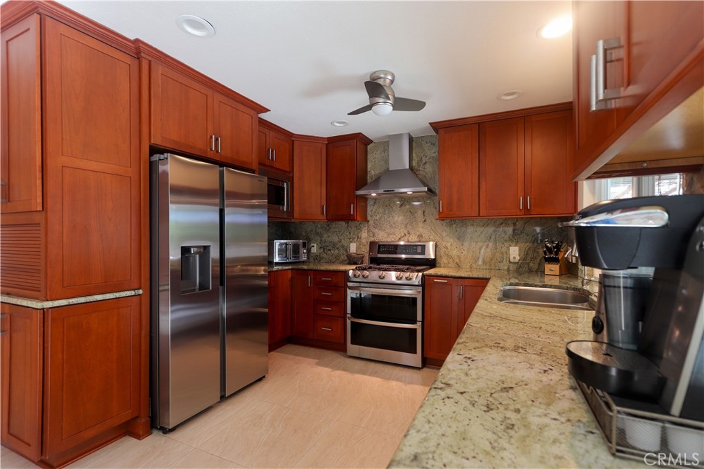 8 Sandpiper Irvine, CA 92604 - Photo 18 of 45 a kitchen with stainless steel appliances granite countertop a refrigerator a stove a sink and a refrigerator