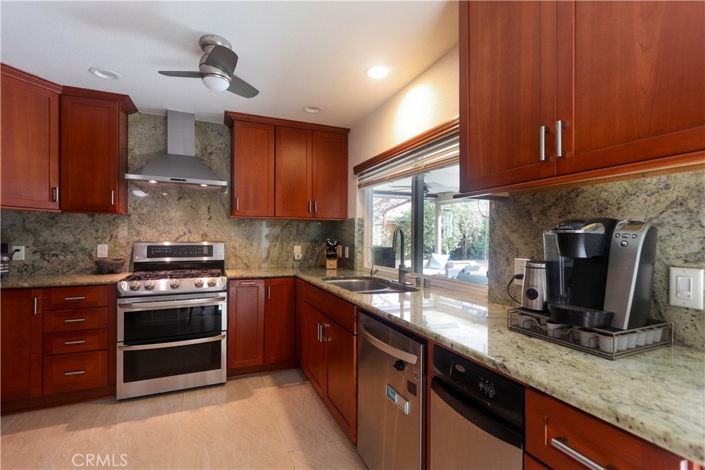 8 Sandpiper Irvine, CA 92604 - Photo 19 of 45 a kitchen with stainless steel appliances granite countertop a stove a sink and a microwave