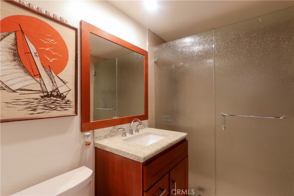 8 Sandpiper Irvine, CA 92604 - Photo 22 of 45 a bathroom with a sink and mirror with bathtub