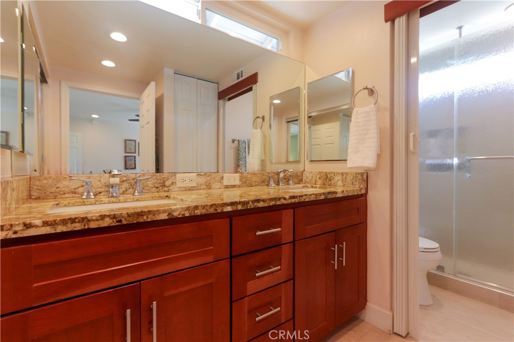 8 Sandpiper Irvine, CA 92604 - Photo 27 of 45 a bathroom with a granite countertop sink and a mirror
