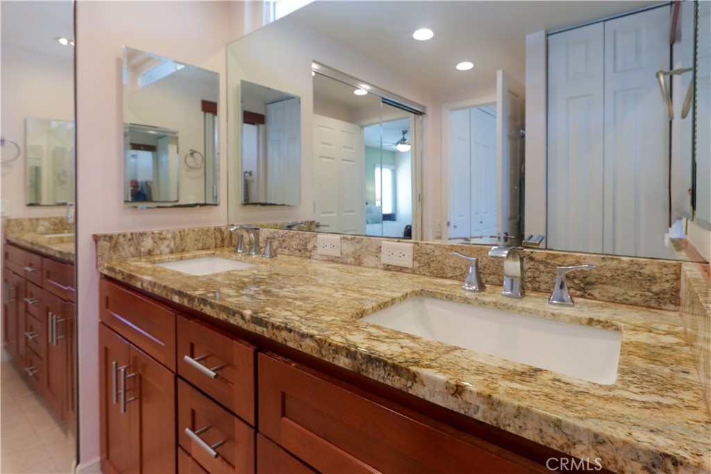 8 Sandpiper Irvine, CA 92604 - Photo 28 of 45 a bathroom with a granite countertop sink and a mirror