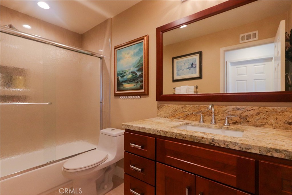 8 Sandpiper Irvine, CA 92604 - Photo 30 of 45 a bathroom with a granite countertop sink toilet and shower