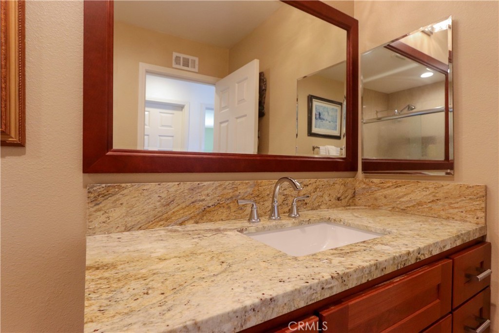 8 Sandpiper Irvine, CA 92604 - Photo 31 of 45 a bathroom with a granite countertop sink and a mirror